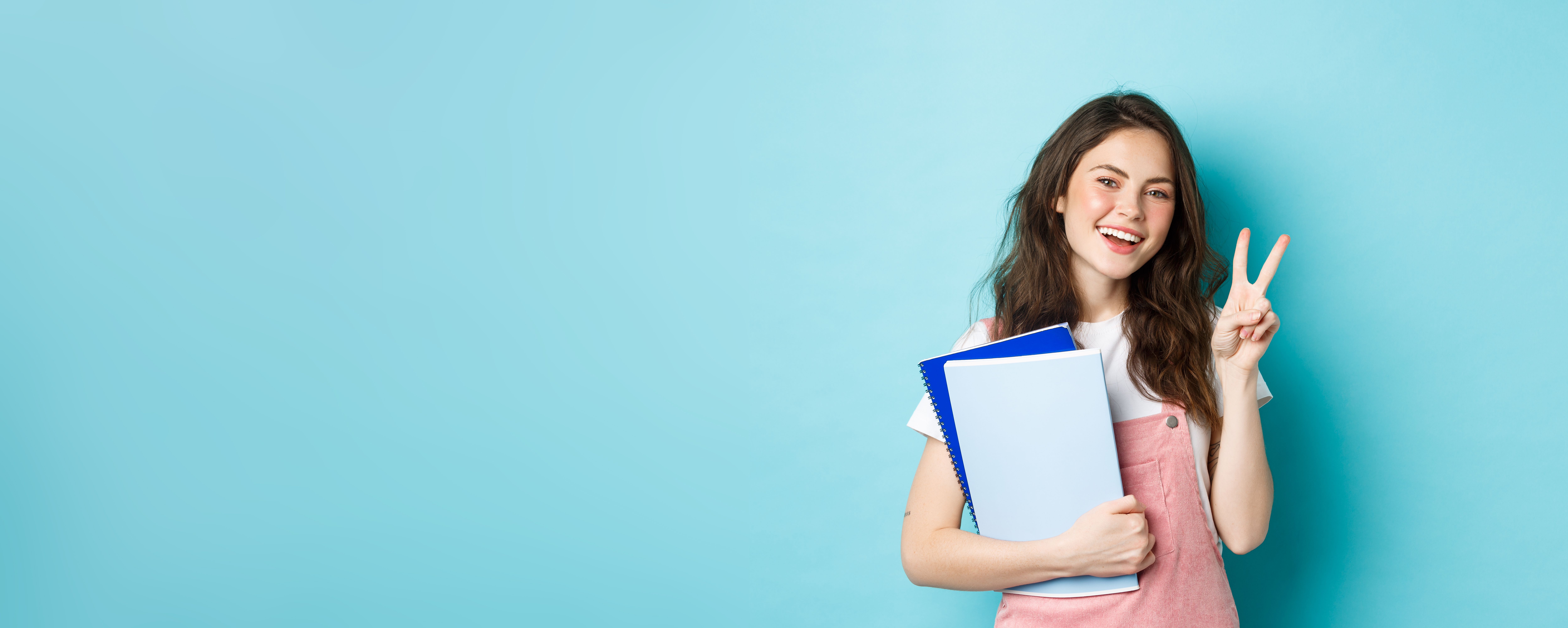 beautiful-female-student-showing-vsign-smiling-happy-holding-notebooks-with-study-material-atten.jpg