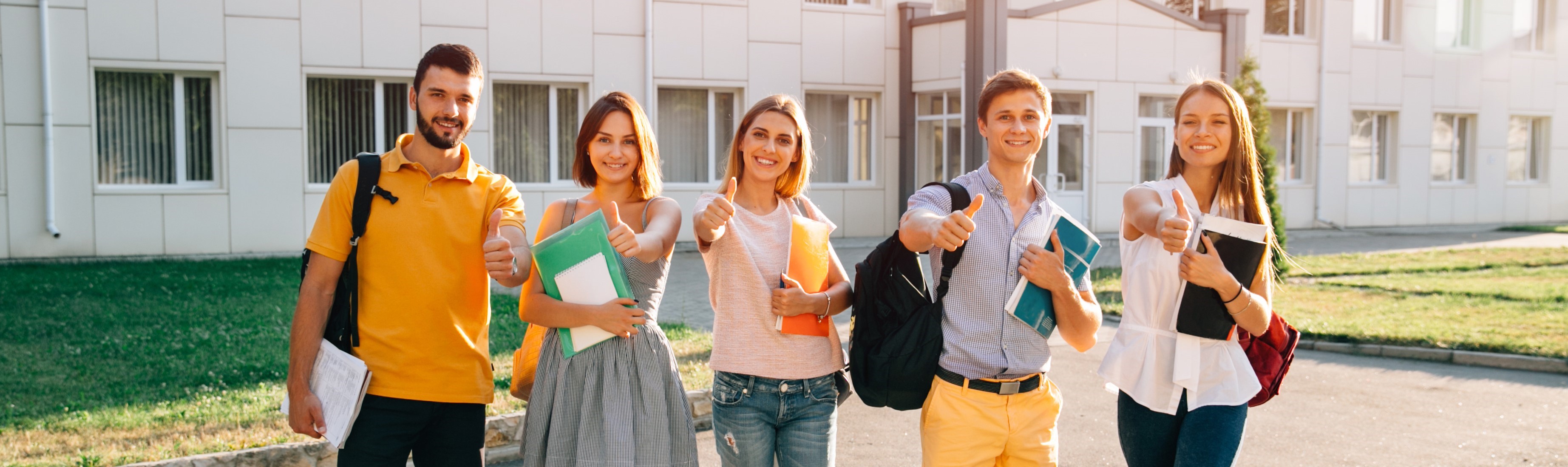 portrait-group-happy-students-casual-outfit-with-books-showing-thumbs-up_copy.jpg